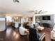 Open-concept living space featuring hardwood floors, a stone fireplace, and an open kitchen with an island at 205 Old Greensboro Rd, Chapel Hill, NC 27516