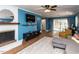 Inviting living room boasts stylish fireplace, big screen TV, and access to a deck with outside views at 205 Old Greensboro Rd, Chapel Hill, NC 27516