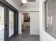 The mudroom features a sliding barn door to a laundry room and access to the back deck through French doors at 205 Old Greensboro Rd, Chapel Hill, NC 27516