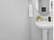 Bathroom featuring a pedestal sink, decorative mirror, and neutral color palette at 211 Explorer Dr # 263, Morrisville, NC 27560