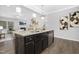 Open-concept kitchen with a large island and view of the adjacent living area at 211 Explorer Dr # 263, Morrisville, NC 27560