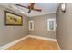 Cozy bedroom features wallpapered walls, hardwood floors, and two small windows at 2122 Woodland Ave, Raleigh, NC 27608