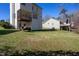 Backyard featuring a house with a small deck and porch, and a woodpile at 213 Yellow Poplar Ave, Wake Forest, NC 27587