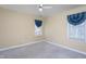 Bedroom with neutral walls, gray carpet, two windows and a ceiling fan at 213 Yellow Poplar Ave, Wake Forest, NC 27587