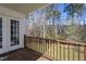Outdoor deck with view of trees and a partially obscured lawn area at 213 Yellow Poplar Ave, Wake Forest, NC 27587