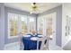 Bright dining nook with a table for four, surrounded by windows and access to the outdoors at 213 Yellow Poplar Ave, Wake Forest, NC 27587