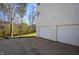 View of the side of the house with a two-car garage and well-maintained exterior at 213 Yellow Poplar Ave, Wake Forest, NC 27587