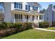 Charming two-story home with a welcoming front porch and landscaped yard at 213 Yellow Poplar Ave, Wake Forest, NC 27587