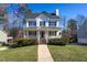 Charming two-story home with a welcoming front porch, classic black shutters, and landscaped front yard at 213 Yellow Poplar Ave, Wake Forest, NC 27587
