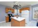 Functional kitchen featuring oak cabinets, center island, and ample counter space, ready for cooking at 213 Yellow Poplar Ave, Wake Forest, NC 27587