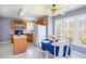 Bright, airy kitchen with oak cabinets, a center island, and a charming dining nook with natural light at 213 Yellow Poplar Ave, Wake Forest, NC 27587