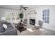 Cozy living room offers a fireplace and large windows, creating a bright and inviting space at 213 Yellow Poplar Ave, Wake Forest, NC 27587