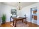 Well-lit home office with hardwood floors, chandelier, and plenty of space for a desk and decor at 213 Yellow Poplar Ave, Wake Forest, NC 27587