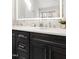 Bathroom vanity featuring double sinks, white countertops, dark wood cabinets, and an LED mirror at 2325 Old Oak Pl, Hillsborough, NC 27278