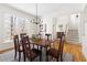Formal dining room features wood floors, a chandelier, and plenty of space for entertaining at 2325 Old Oak Pl, Hillsborough, NC 27278