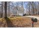 Charming gray home with green shutters, white garage door, and a long driveway surrounded by trees at 2325 Old Oak Pl, Hillsborough, NC 27278