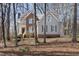 Two-story home with brick and siding exterior, complemented by mature trees and a spacious front yard at 2325 Old Oak Pl, Hillsborough, NC 27278