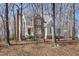 Charming two-story home with brick and siding exterior, surrounded by mature trees and landscaping at 2325 Old Oak Pl, Hillsborough, NC 27278