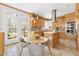 Eat-in kitchen with wooden cabinetry, stainless appliances, and lots of windows at 2325 Old Oak Pl, Hillsborough, NC 27278