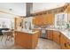 Bright eat-in kitchen with stainless appliances, mosaic backsplash, and a center island with white countertop at 2325 Old Oak Pl, Hillsborough, NC 27278