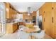 Eat-in kitchen with wooden cabinetry, stainless appliances, and lots of windows at 2325 Old Oak Pl, Hillsborough, NC 27278