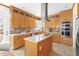 Bright eat-in kitchen with stainless appliances, mosaic backsplash, and a center island with white countertop at 2325 Old Oak Pl, Hillsborough, NC 27278