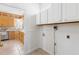Well-lit laundry room featuring white cabinets and washer-dryer hookups at 2325 Old Oak Pl, Hillsborough, NC 27278