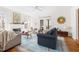 Open-concept living room with fireplace, access to outdoors, and modern decor, hardwood floors at 2325 Old Oak Pl, Hillsborough, NC 27278