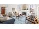 Bright living room with fireplace, large windows, and stylish decor, including a patterned rug at 2325 Old Oak Pl, Hillsborough, NC 27278