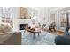 Cozy living room with fireplace, natural light, and stylish decor, featuring hardwood floors at 2325 Old Oak Pl, Hillsborough, NC 27278