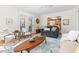 Open-concept living room with French doors and view into the kitchen, featuring hardwood floors at 2325 Old Oak Pl, Hillsborough, NC 27278