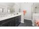 Elegant bathroom with double sinks, soaking tub, glass shower, and marble tile at 2325 Old Oak Pl, Hillsborough, NC 27278
