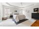Spacious bedroom with recessed tray ceiling, a plush bed, and a dark wood dresser at 2325 Old Oak Pl, Hillsborough, NC 27278