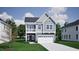 Charming two-story home with gray siding, a balcony, an attached two-car garage, and well-maintained landscaping at 247 Meadowbark Bnd # 29, Garner, NC 27529