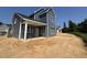 Rear exterior of a blue two-story home with a covered patio and white support beams at 247 Meadowbark Bnd # 29, Garner, NC 27529