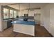 Modern kitchen with white cabinets, an island, stainless steel appliances, and tile backsplash at 247 Meadowbark Bnd # 29, Garner, NC 27529