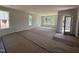 Spacious living room with hardwood floors, light walls, and multiple windows at 247 Meadowbark Bnd # 29, Garner, NC 27529