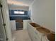 Bathroom under construction with a window, cabinets, and visible plumbing at 251 Meadowbark Bnd # 30, Garner, NC 27529