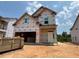 Under construction two-story home with visible framing and window openings at 251 Meadowbark Bnd # 30, Garner, NC 27529