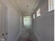 Hallway view featuring white walls, a tray ceiling, and an open doorway at the end of the hall at 251 Meadowbark Bnd # 30, Garner, NC 27529