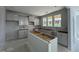Spacious kitchen with white cabinets, an island, and multiple windows for natural light at 251 Meadowbark Bnd # 30, Garner, NC 27529