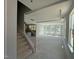 Open living room featuring large windows, stairs, and a view of the kitchen at 251 Meadowbark Bnd # 30, Garner, NC 27529