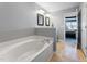 Relaxing bathroom featuring a soaking tub, neutral walls, and tiled floor at 2822 Casona Way, Raleigh, NC 27616