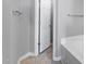 Bright bathroom featuring a white door next to a deep soaking tub at 2822 Casona Way, Raleigh, NC 27616
