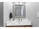 Clean bathroom featuring a white sink and vanity, framed mirror, and essential fixtures at 2822 Casona Way, Raleigh, NC 27616