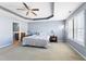 Comfortable bedroom with neutral colors, tray ceiling, a ceiling fan, and ample natural light at 2822 Casona Way, Raleigh, NC 27616