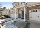 Welcoming entrance with brick accents, columns, and a single-car garage on each side at 2822 Casona Way, Raleigh, NC 27616