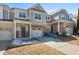 Inviting townhome featuring brick accents, a single car garage, and neutral color palette at 2822 Casona Way, Raleigh, NC 27616