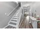 Inviting foyer featuring hardwood floors, stairs to the upper level, and decor at 2822 Casona Way, Raleigh, NC 27616