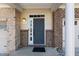 Close-up of the front door featuring a neutral color and decorative window above at 2822 Casona Way, Raleigh, NC 27616